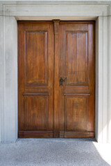 Beautiful brown hardwood doors. Church entrance door, straight view, no people