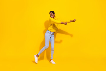 Fototapeta na wymiar Full length body size view of attractive cheerful thin dreamy girl dancing good day isolated over bright yellow color background