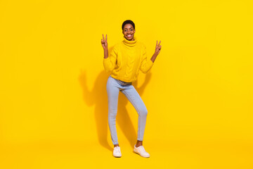 Fototapeta na wymiar Full length body size view of attractive cheerful slender trendy girl showing double v-sign isolated over vivid yellow color background