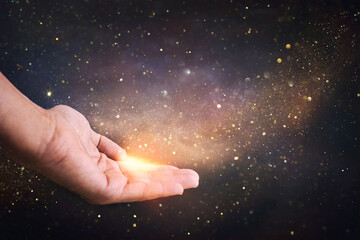 Human hand and magical glowing light