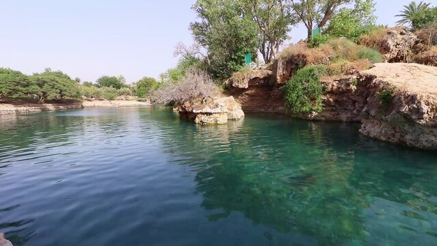 A pool of clear and clean turquoise water in the Gan Hashlosha Nature Reserve in the Valley of the Springs - Israel