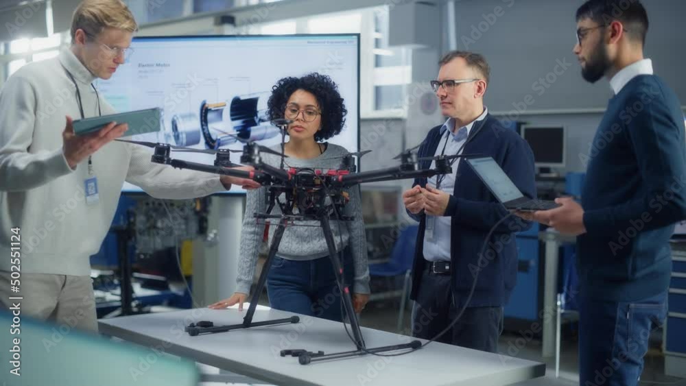 Aufkleber team of aviation engineers work on a new drone, have discussion, use laptop in the scientific labora