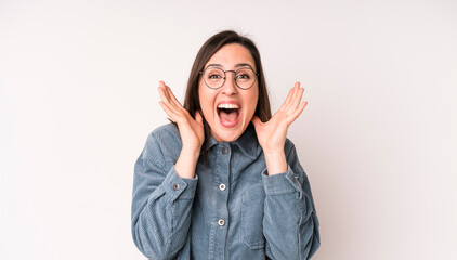 young adult pretty woman feeling shocked and excited, laughing, amazed and happy because of an...