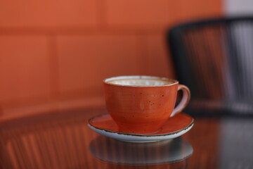 a cup of coffee on glass table in the morning 