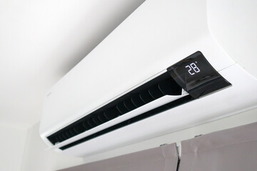 Air conditioner on white wall room interior background