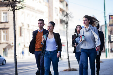 Group of people walking on a street with confidence. Businessmen and businesswomen traveling...