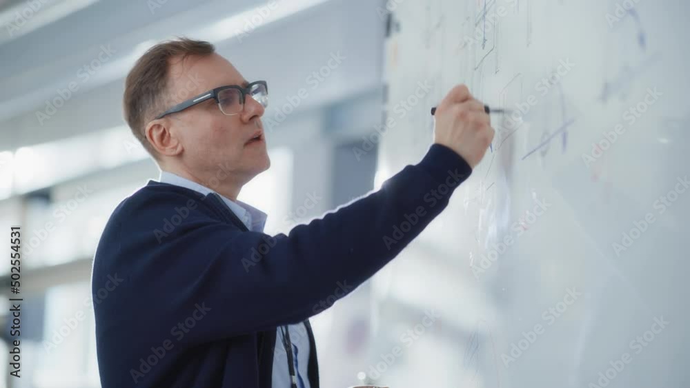 Poster Chief Engineer Writing Formulas on Whiteboard while Hold a Lesson. Solving Problems and Searching New Strategies in Engineering Concept. Portrait View