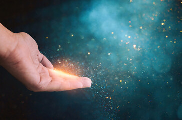 Human hand and magical glowing light