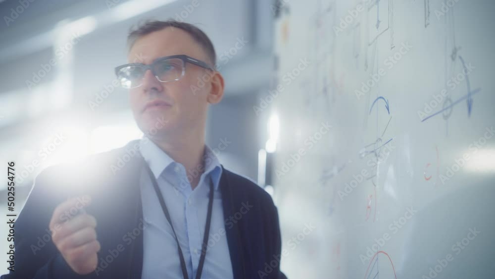 Poster Chief Engineer Talk to Young Specialists and Working with Drafts on a Whiteboard while Discovering New in Engineering. Science and Research Concept. Portrait View