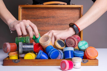 Colorful gouache paints painting in vintage wooden box