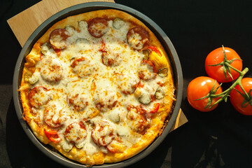 Hot pizza with Pepperoni and tomato, on dark background. Cheese Pizza