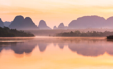 The landscape of the tropical lake during sunrise.