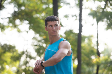 man jogger in activewear checking time on smartwatch