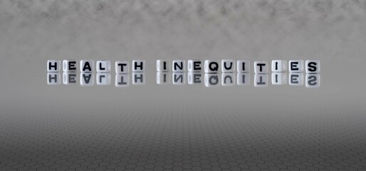 health inequities word or concept represented by black and white letter cubes on a grey horizon...
