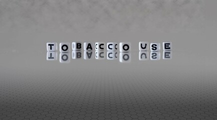 tobacco use word or concept represented by black and white letter cubes on a grey horizon...