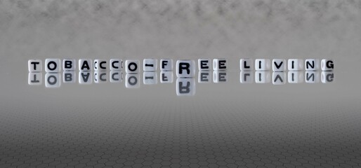 tobacco free living word or concept represented by black and white letter cubes on a grey horizon...