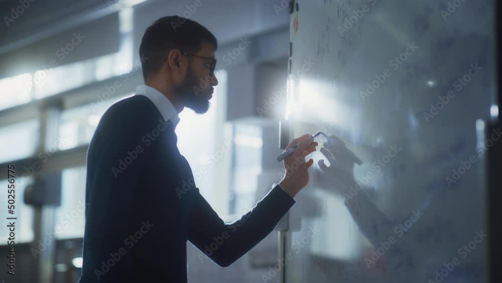 Poster black male scientist solves complex mathematical problems standing at the whiteboard. education, sci