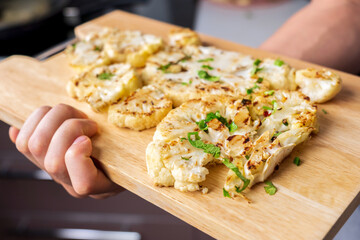 Cauliflower ready steak cooking. Healthy eating, plant-based diet. Vegetarian organic food.