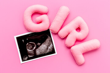 Ultrasound scan of unborn baby with letters girl