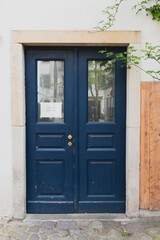 Blue wooden front door entrance with an old feel in European big city