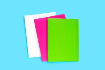Office folders on blue background. Top view