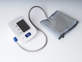 Digital blood pressure monitor on white background. Tonometer