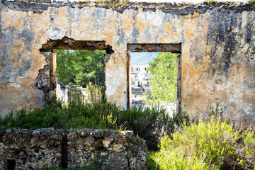 Fototapeta na wymiar Shot of a ruined window on Ghost town Kayakoy Ghost town Kayakoy, Turkey