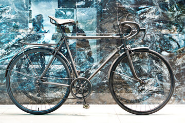 Fototapeta na wymiar Black bicycle near marble wall