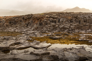 Fototapeta na wymiar Volcanic landscape. Cooled lava is black rocky texture.