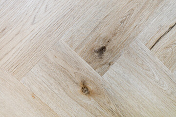 Top view of a parquet floor under natural light. Wooden pattern with oak diagonal texture.