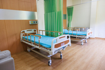 Two beds in common patient room.  Recovery Room with beds and comfortable medical. Interior of an empty hospital room. Clean and empty room with a bed in the new medical center