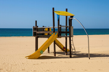 Structure with slides for children's games on the beach, facing the sea