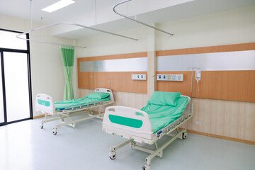 Two beds in common patient room.  Recovery Room with beds and comfortable medical. Interior of an empty hospital room. Clean and empty room with a bed in the new medical center