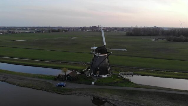 Three Dutch mills in 'polder' landscape Leidschendam, the Netherlands filmed with drone