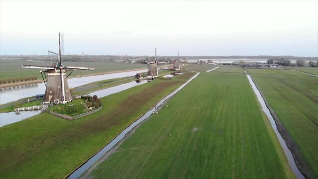 Three Dutch mills in 'polder' landscape Leidschendam, the Netherlands filmed with drone