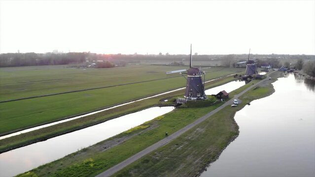 Three Dutch mills in 'polder' landscape Leidschendam, the Netherlands filmed with drone