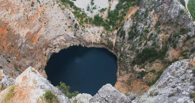Wonderful karst Red Lake Crveno jezero in Croatia. Cliffs and forest