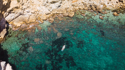 Dronie view of a paddle surf in a beach.