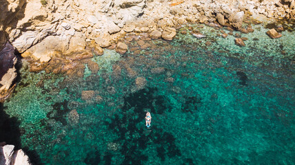 Dronie view of a paddle surf in a beach.