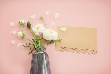 Top view image of white flowers composition over pink pastel background