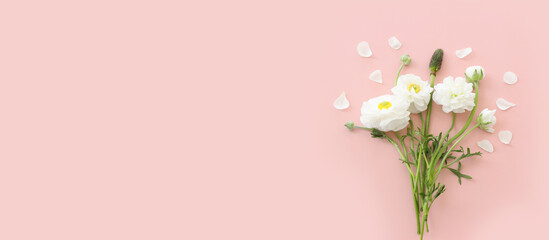 Top view image of white flowers composition over pink pastel background