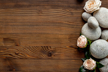 Fototapeta na wymiar Spa treatment with stones and pink roses, top view