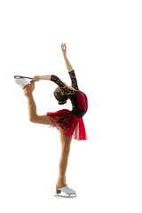 Portrait of little flexible girl, figure skater wearing stage attire posing isolated on white studio backgound. Concept of movement, sport, beauty. © master1305