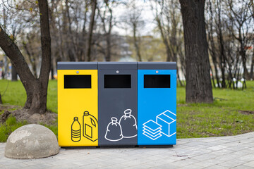 sorting trash cans of different colors in the park