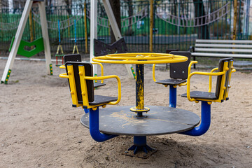 empty iron carousel in the playground of the city