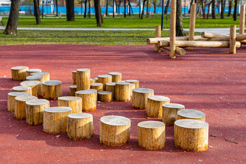wooden stumps for walking on the playground - obrazy, fototapety, plakaty