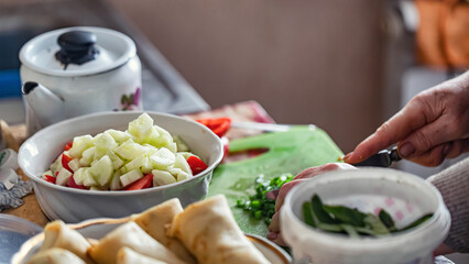 Preparation of fresh vegetable salad in the old kitchen
