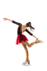 Portrait of little flexible girl, figure skater wearing stage attire posing isolated on white...