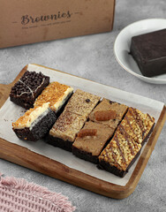 Assorted flavors of brownies topped with chocolate cheese and nuts