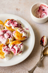 Cottage cheese pancakes, syrniki, ricotta fritters on white ceramic plate with sour cream and jam. Healthy and delicious morning breakfast. Beige background. Food for kids